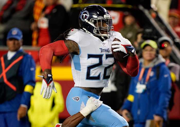 Tennessee Titans running back Derrick Henry (22) rushes for a first down while pursued by Kansas City Chiefs safety Justin Reid (20) during the second quarter at GEHA Field at Arrowhead Stadium Sunday, Nov. 6, 2022, in Kansas City, Mo.